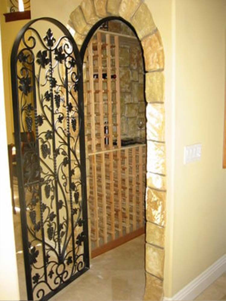 A wrought iron gate leading to a wine cellar