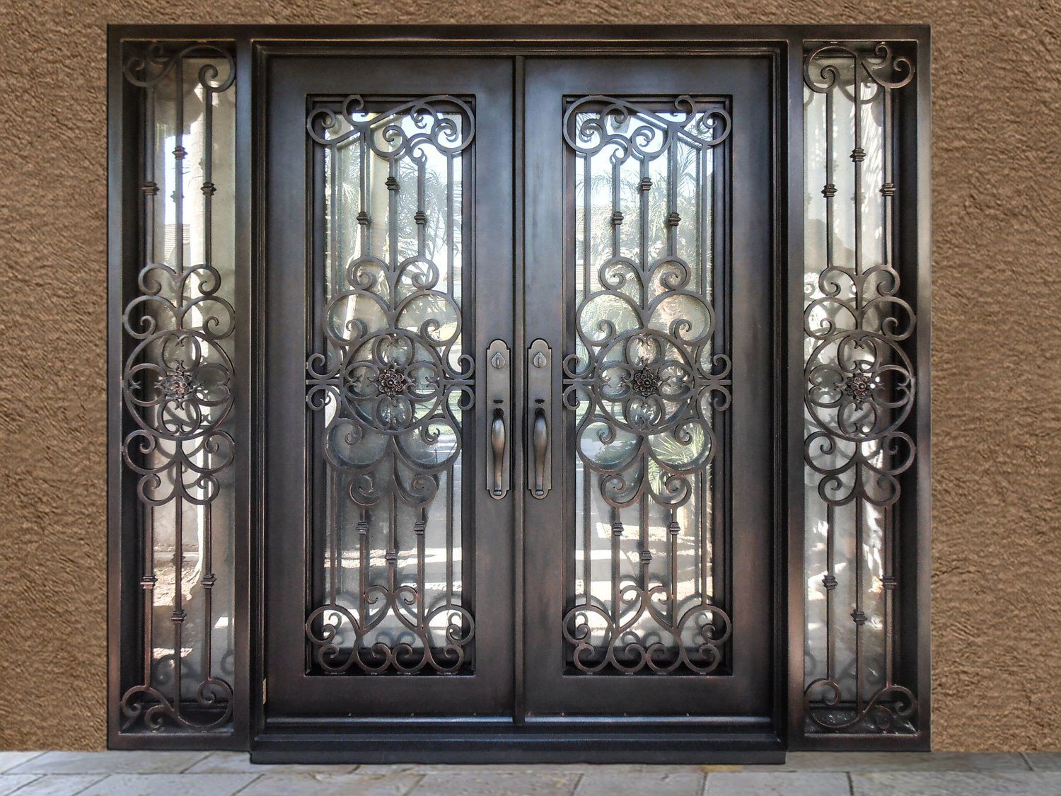A wrought iron door with a fancy design on it