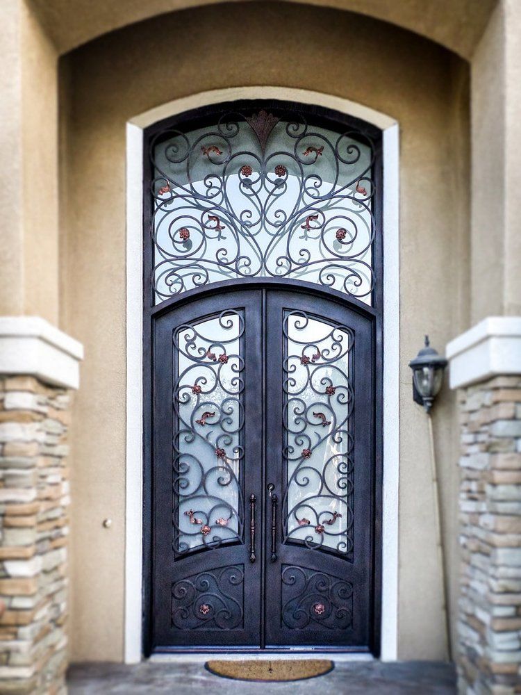 The front door of a house has a wrought iron design on it
