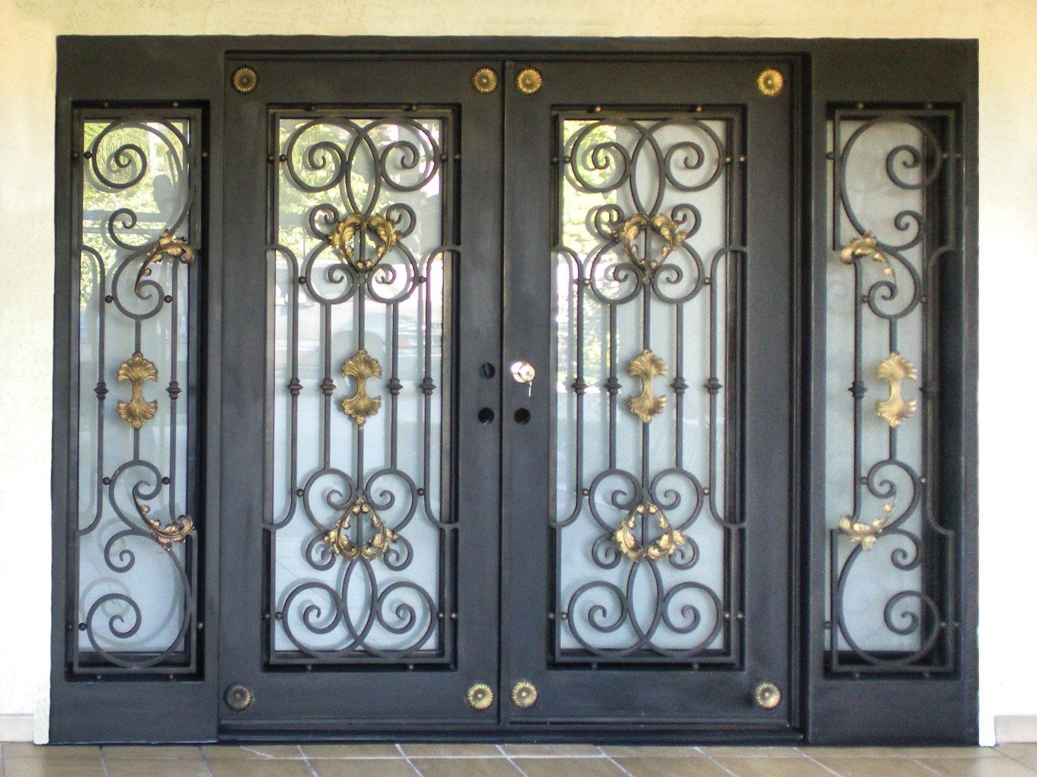 A wrought iron door with swirls and flowers on it