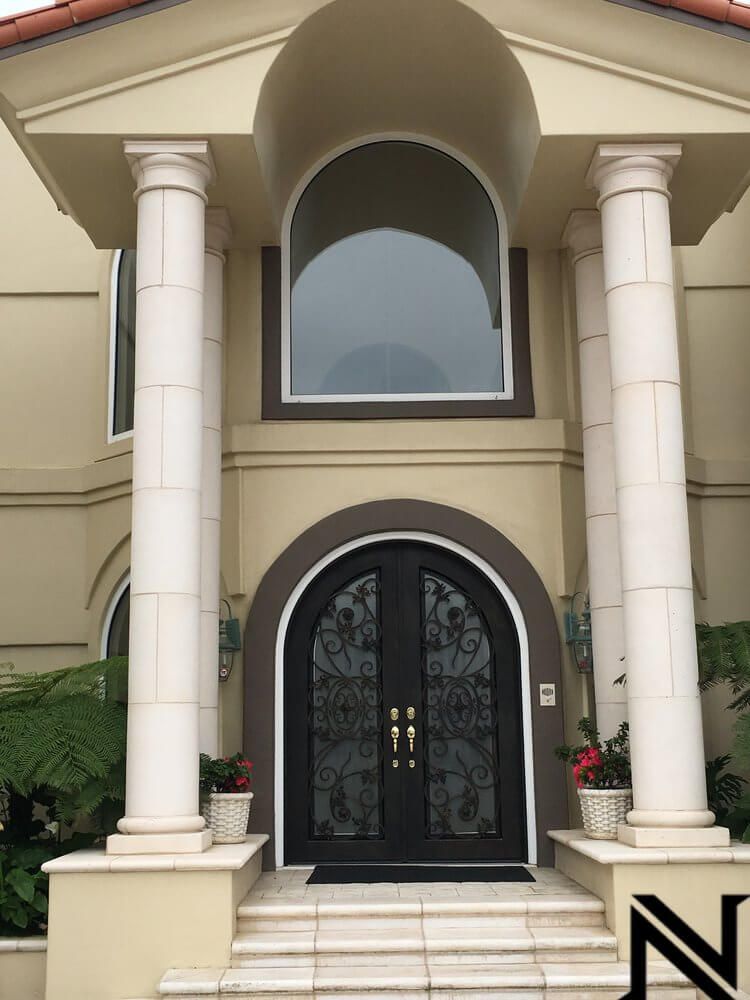 A large house with columns and a n on the side