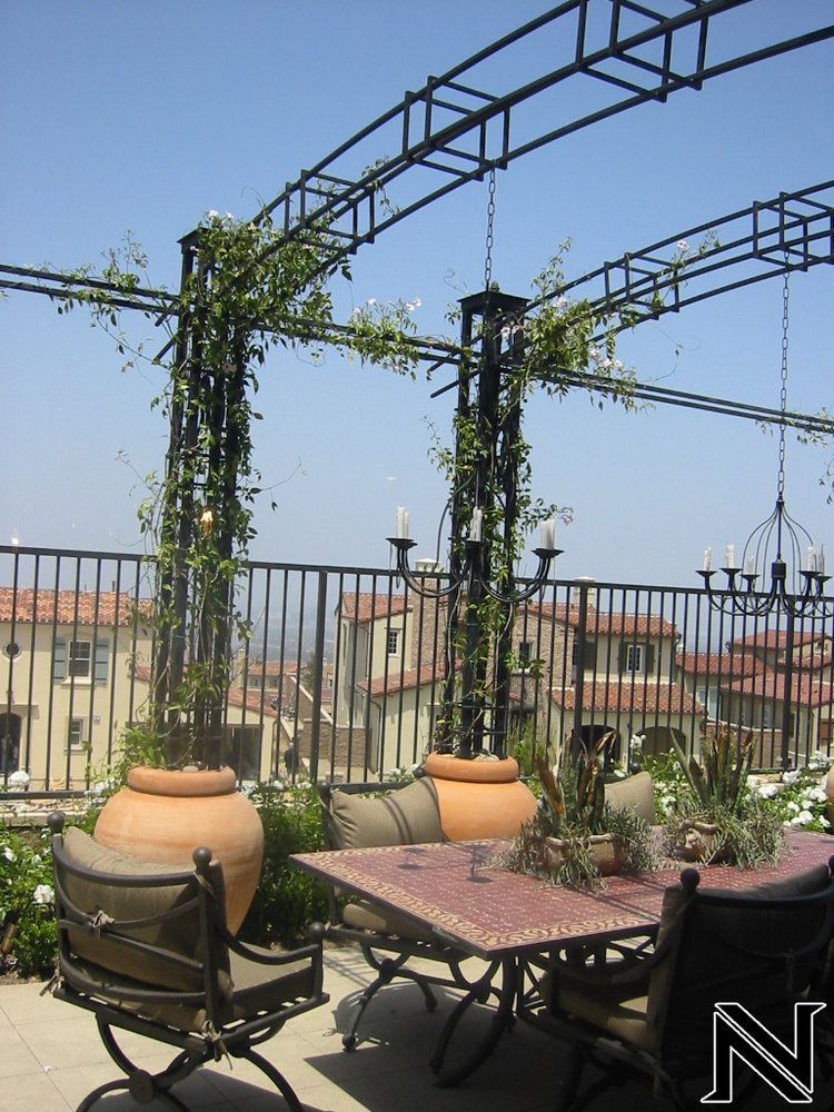 A patio with a table and chairs and the letter n on the bottom