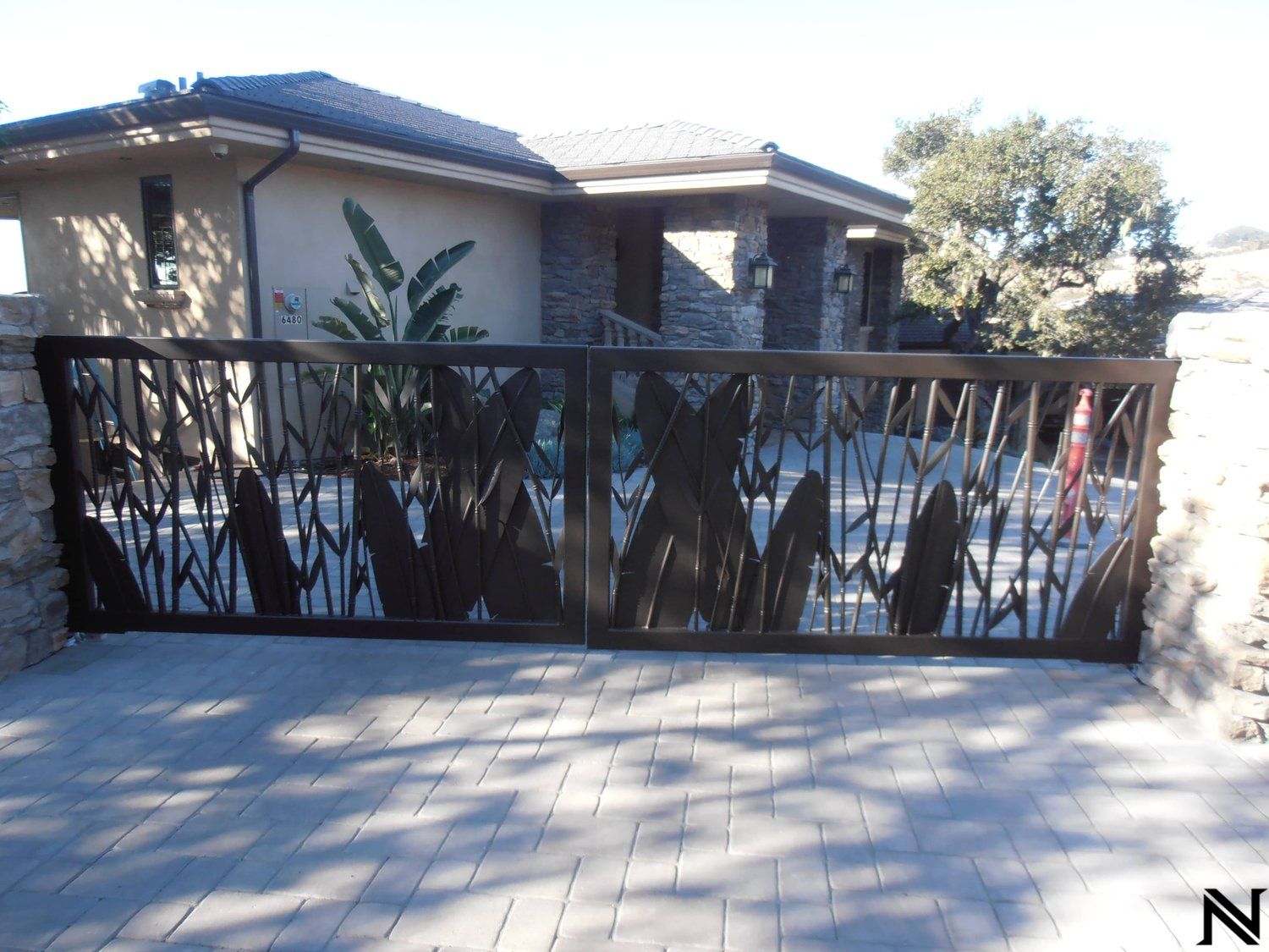 A house with a gate that says n on it