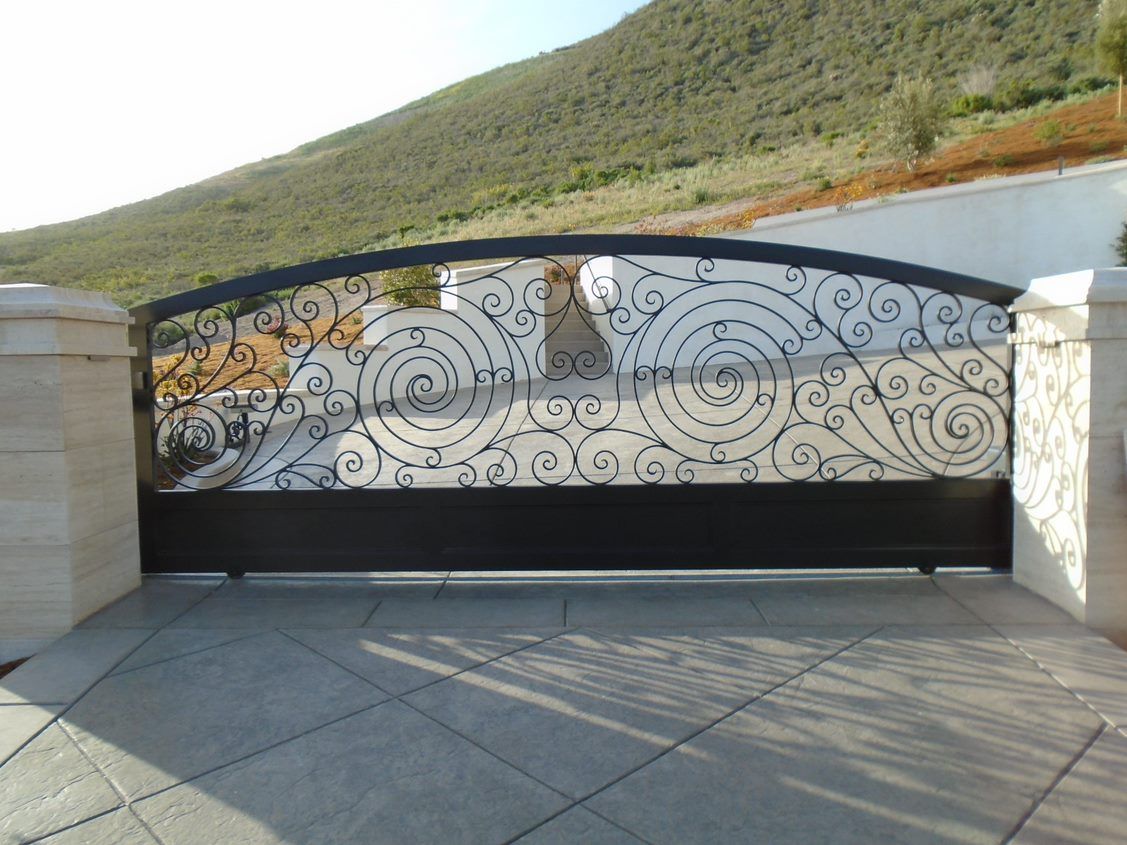 A wrought iron gate with a swirl design on it