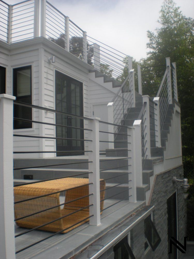 A white house with stairs leading up to it