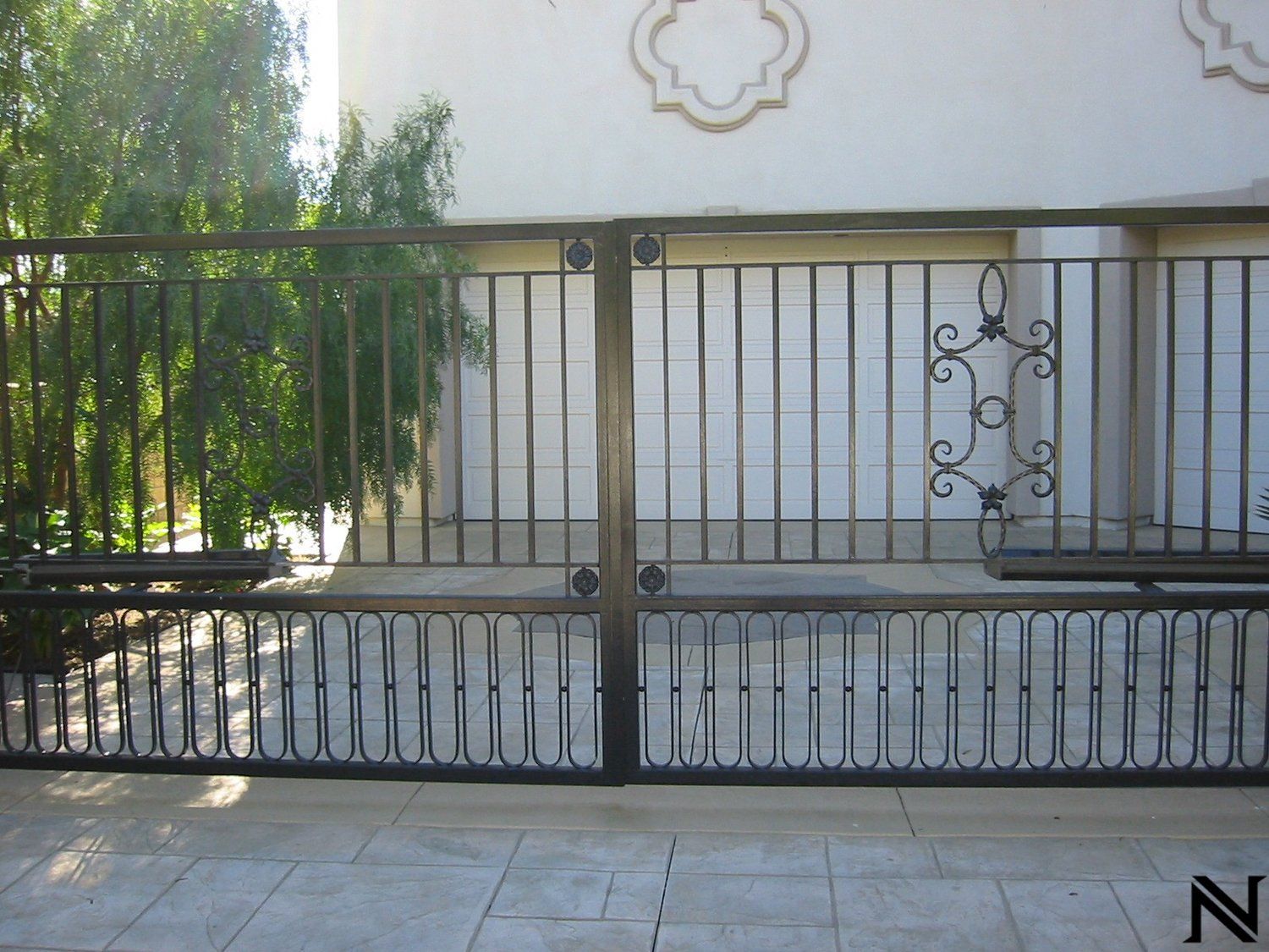 A wrought iron gate with the letter n on it