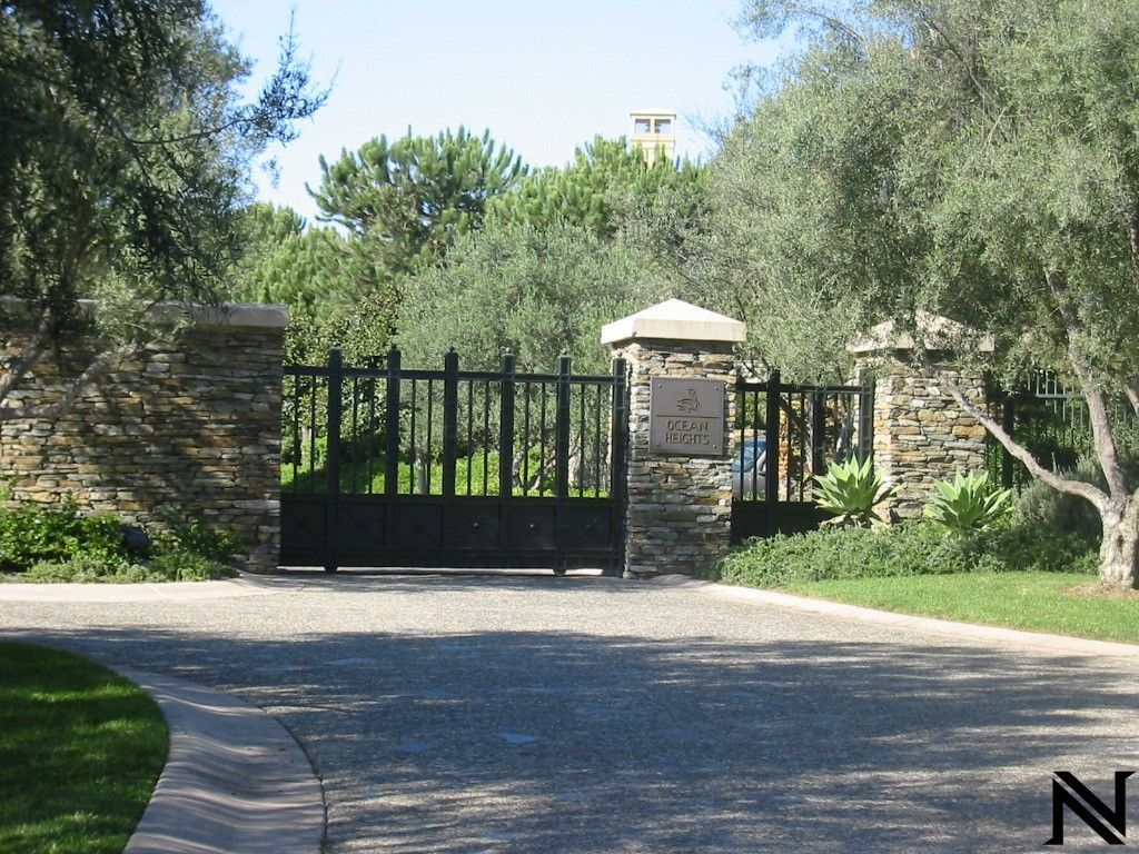 A black gate with the letter n on it