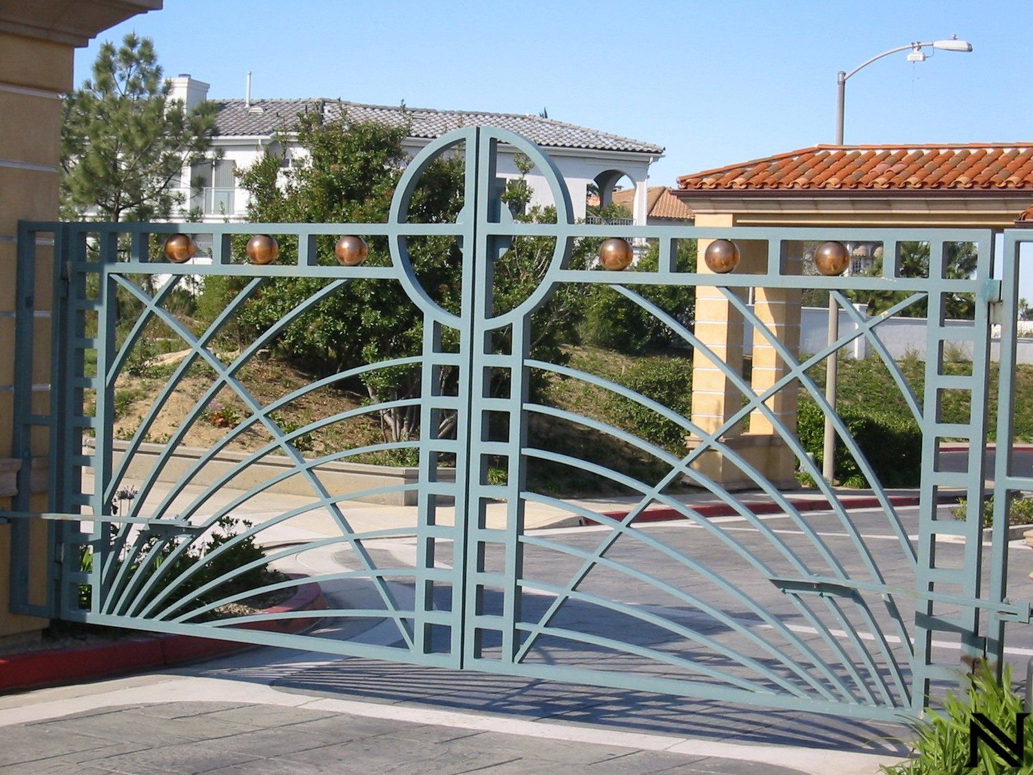A wrought iron gate with a circular design on it