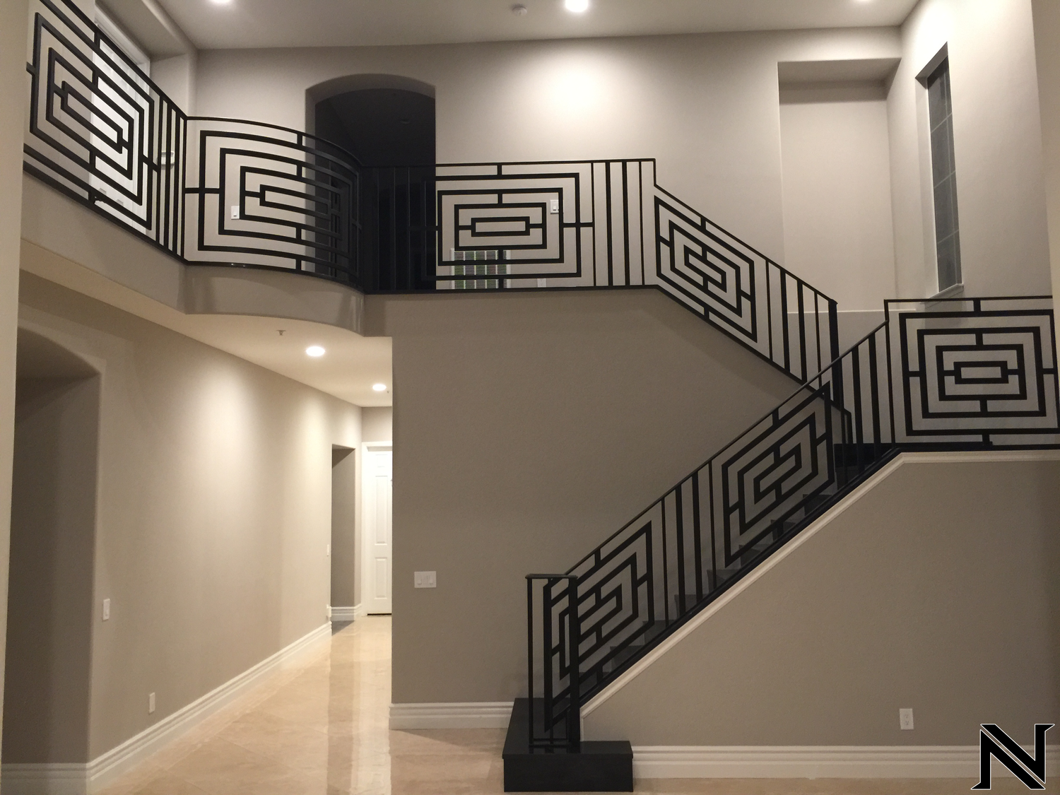 A staircase with a wrought iron railing in a house