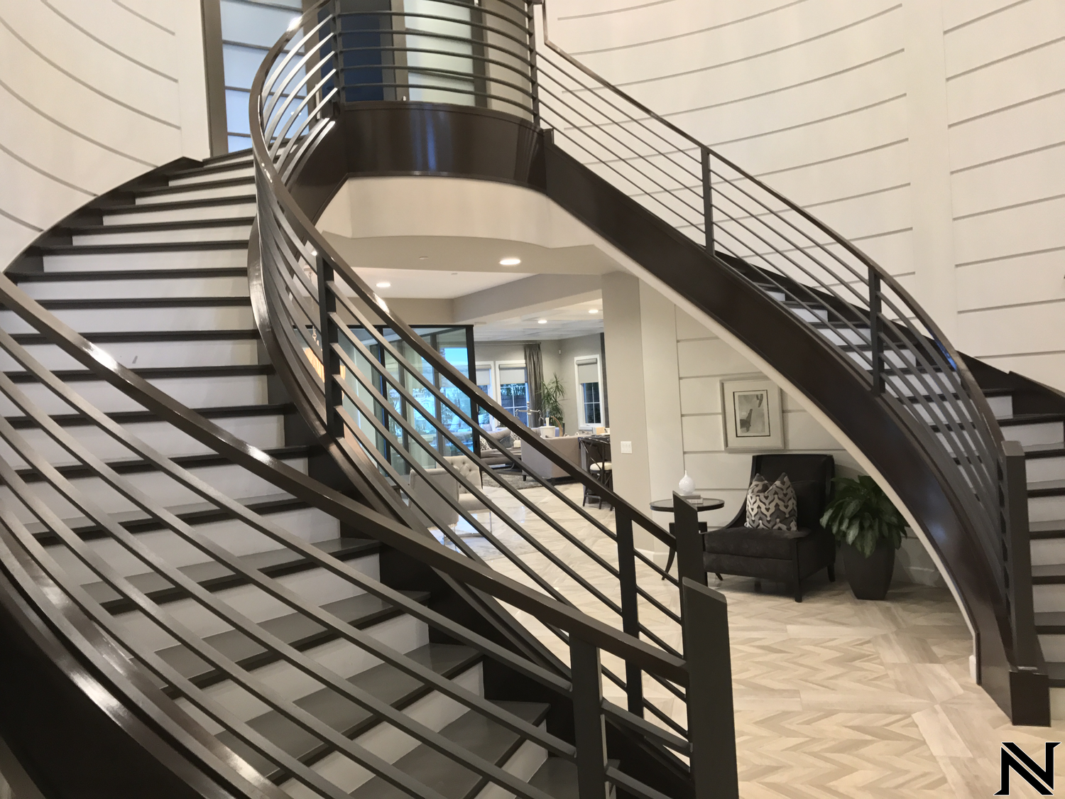 A spiral staircase in a house with a metal railing