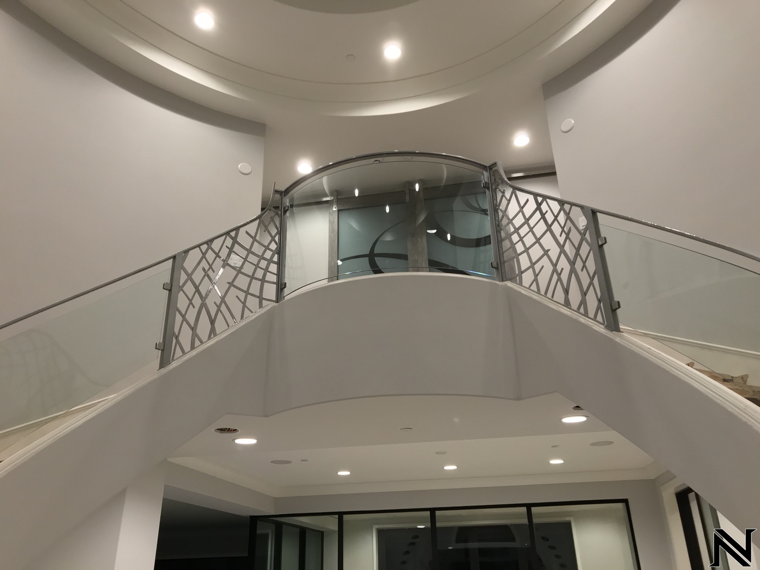 A staircase with a glass railing in a building