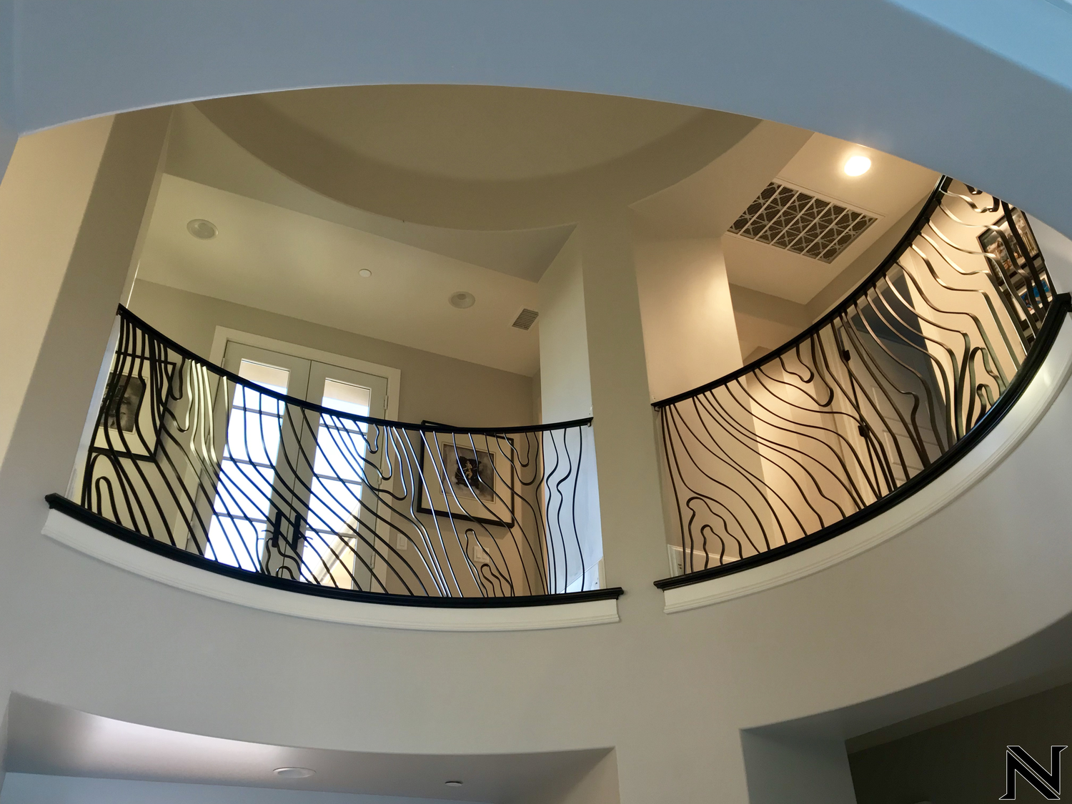 A circular staircase with a zebra print railing