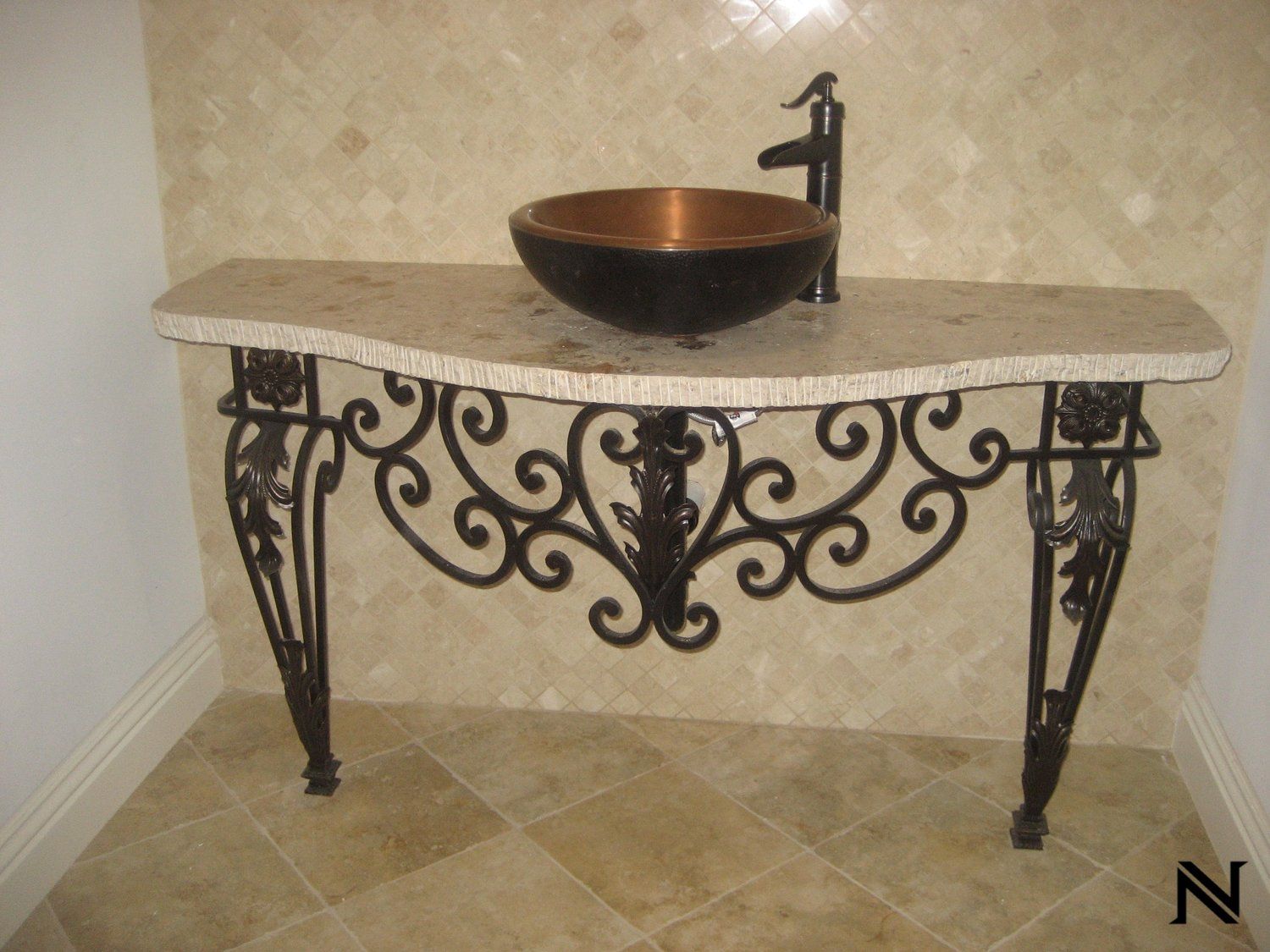 A wrought iron table with a sink on top of it