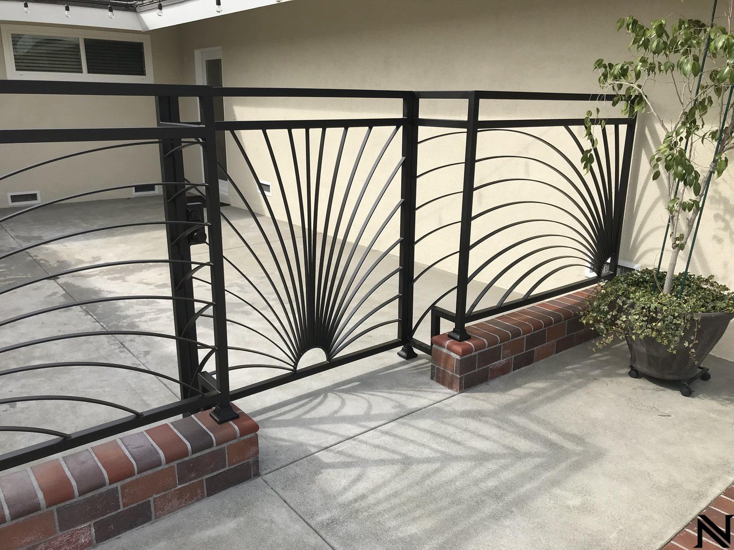 A wrought iron fence with a fan design on it