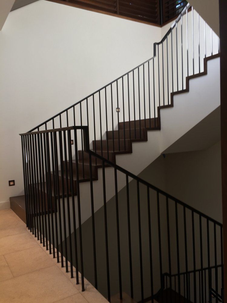 A staircase with a metal railing and wooden steps