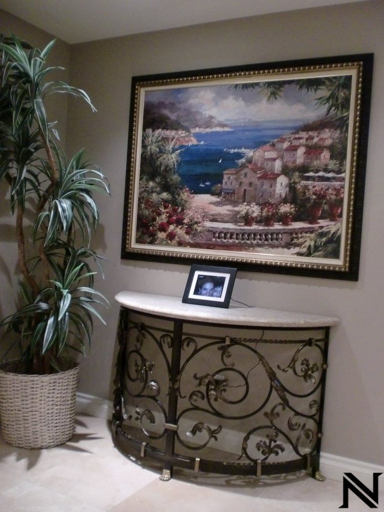 A picture on a wall above a table with the letter n on it