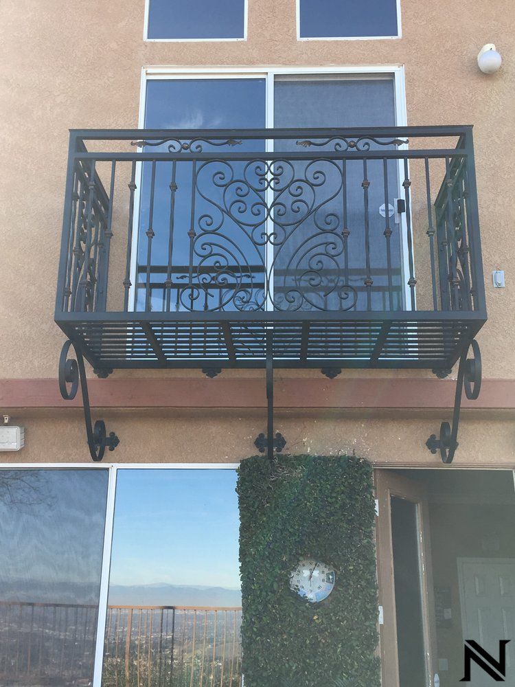 A balcony on the side of a building with the letter n on it