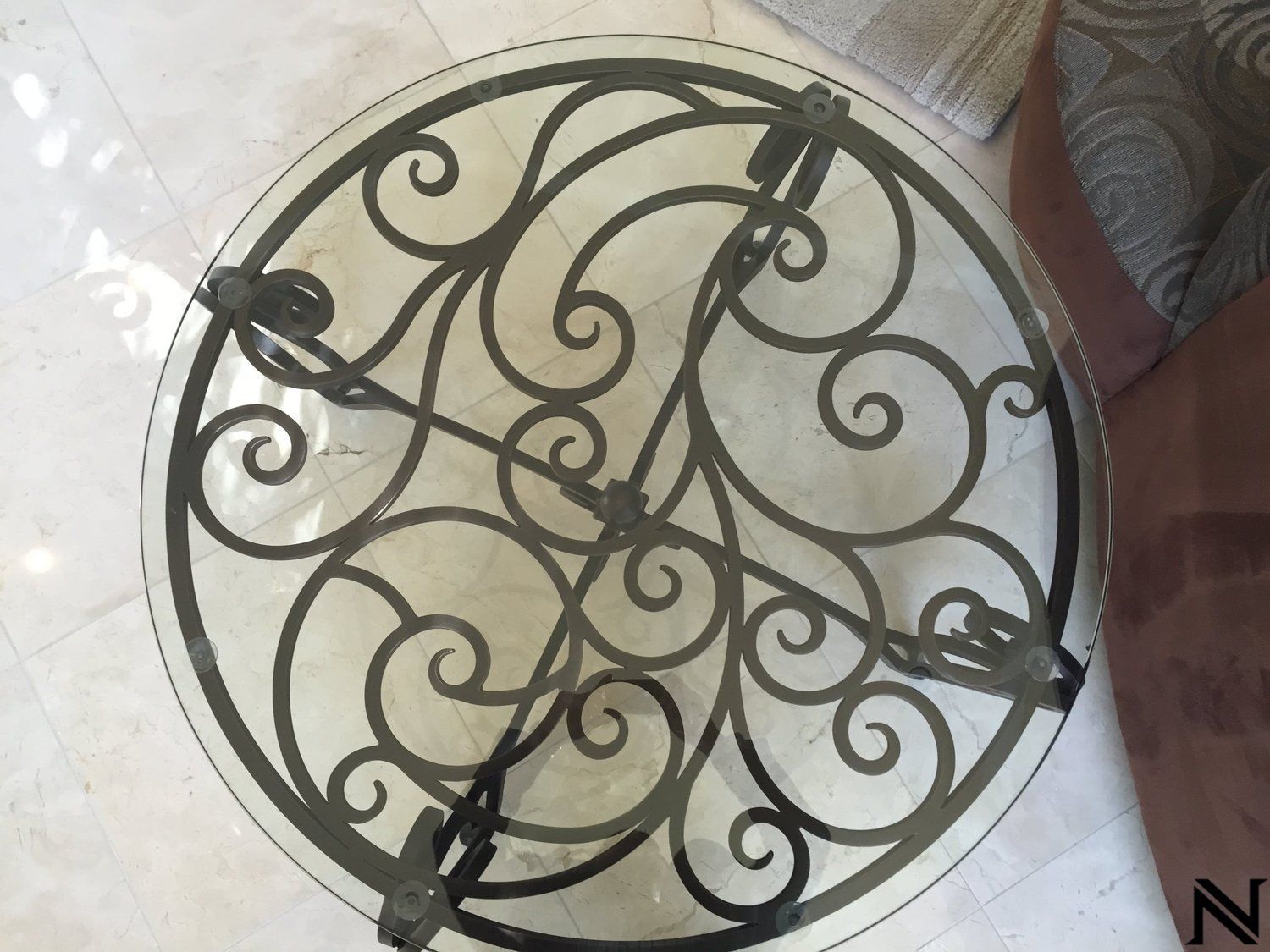 A round table with a wrought iron design on it