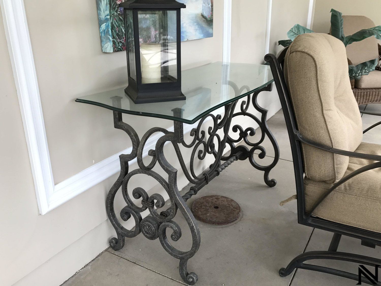 A glass table with a lantern on top of it in a living room.