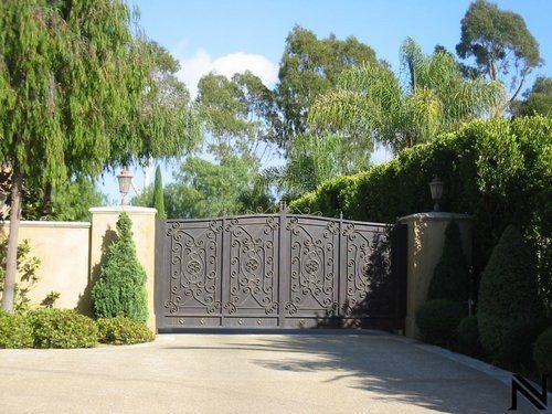 A gated driveway with the letter z on the side