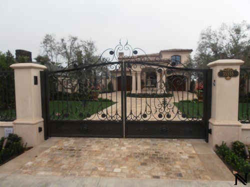 A large house with a wrought iron gate in front of it