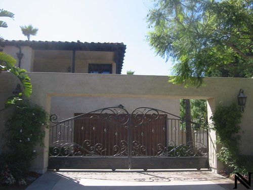 A house with a gate that says n on it