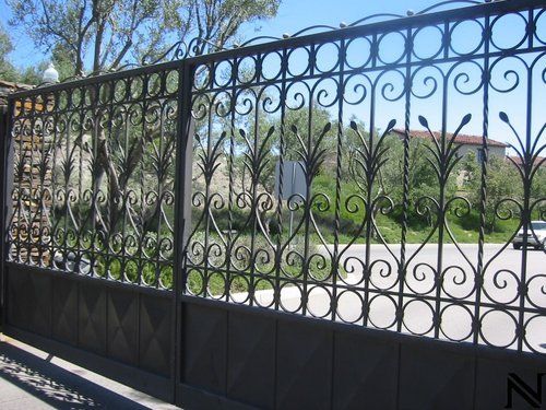 A wrought iron fence with a swirl design on it