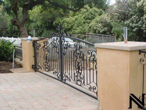 A wrought iron gate with the letter n on it