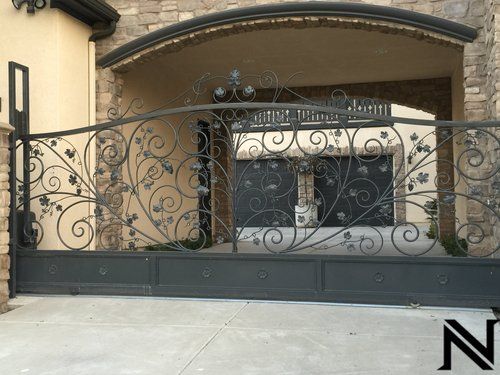 A wrought iron gate with the letter n on it
