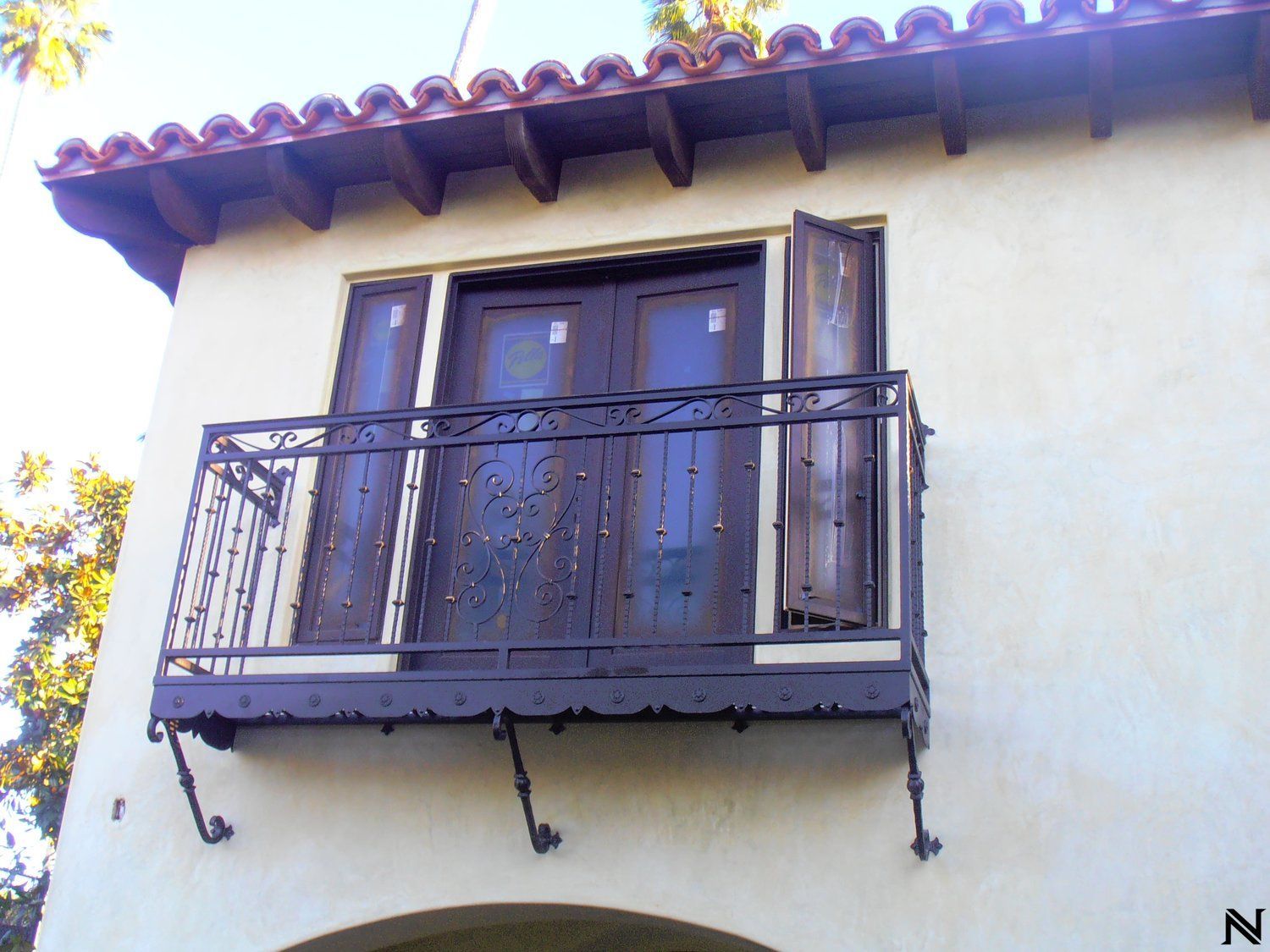 A balcony on the side of a building with the letter n below it