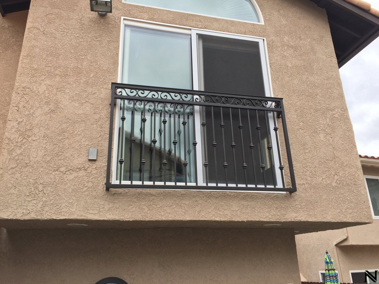 A house with a balcony and a sliding glass door