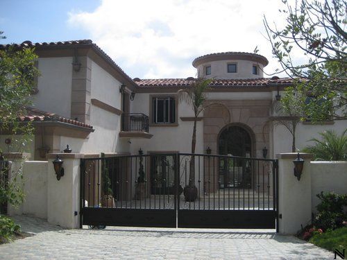 A large white house with a black gate in front of it