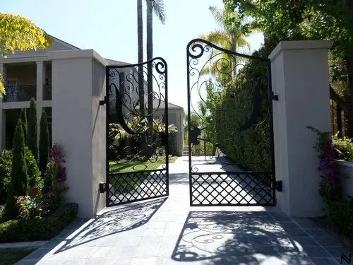 A close up of a wrought iron door with a pattern on it