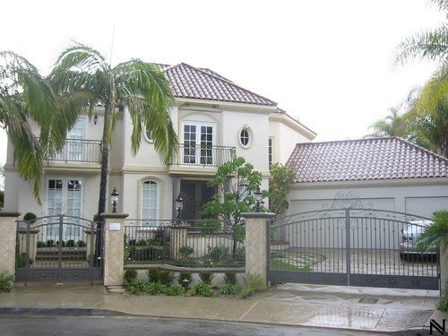 A large white house with a car parked in front of it