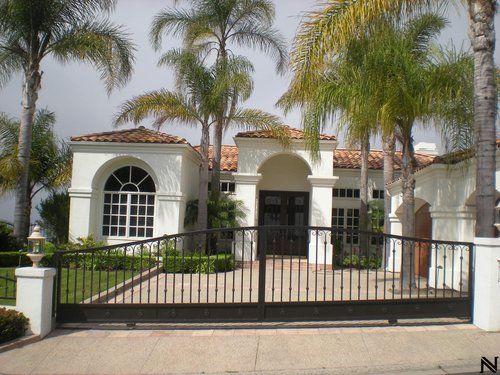 A white house with palm trees in front of it