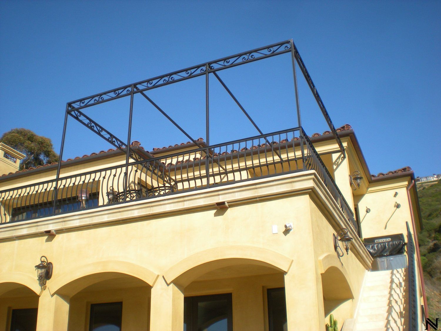 A large yellow building with a balcony on top of it