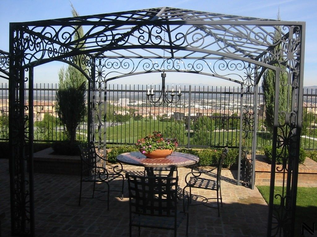 A gazebo with a table and chairs underneath it