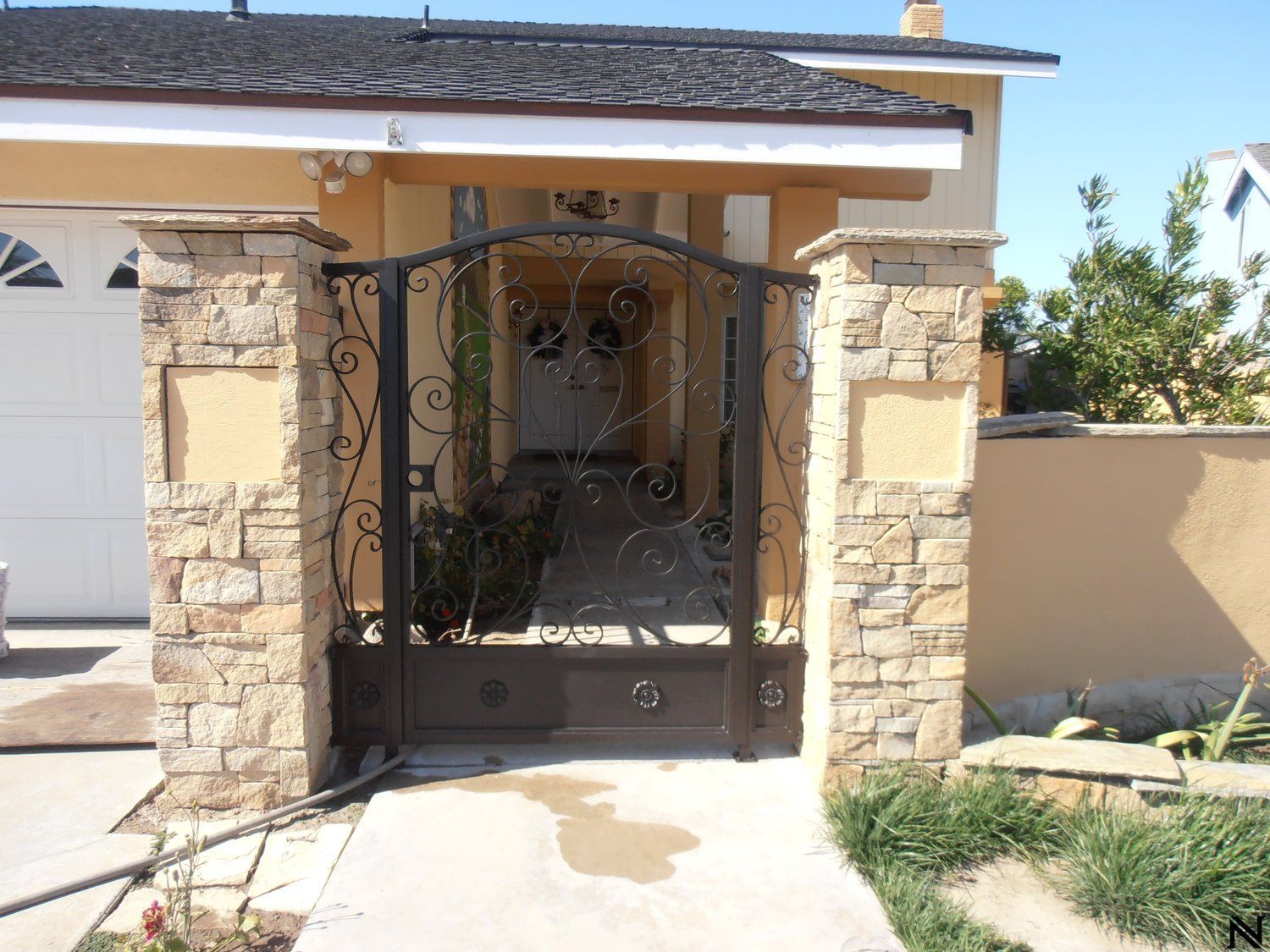 A house with a wrought iron gate in front of it