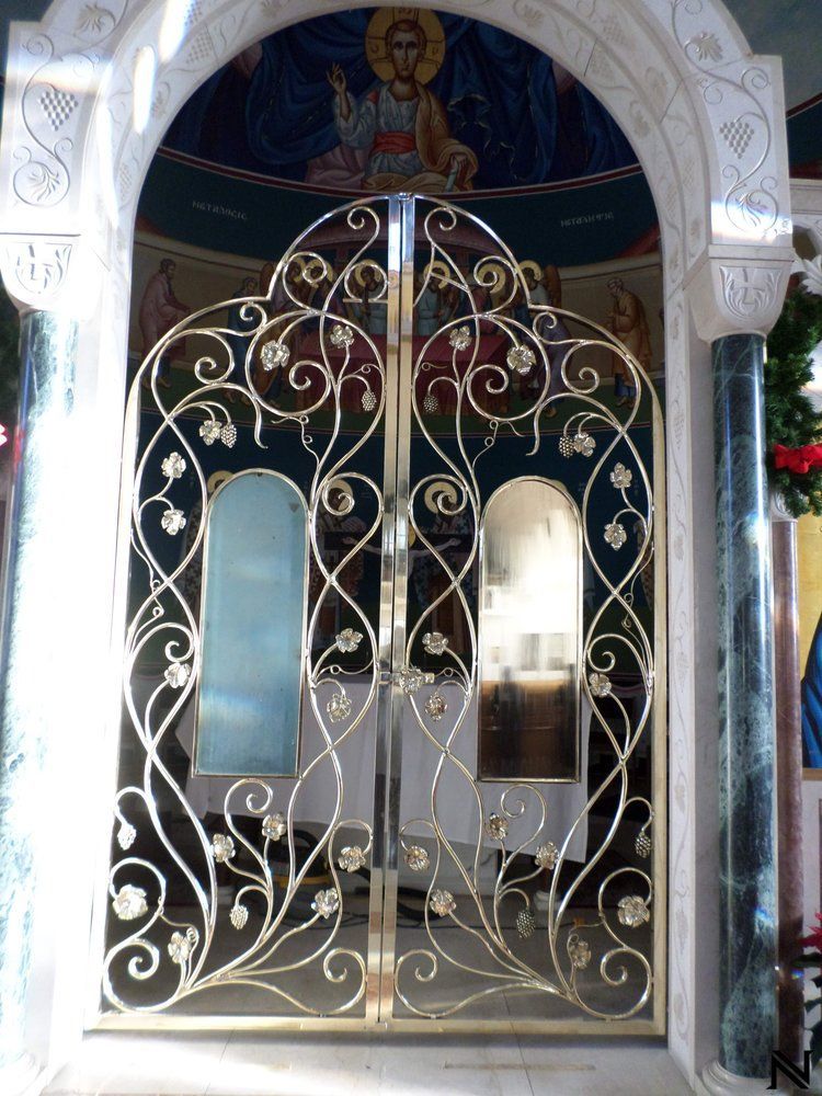 A wrought iron gate with a picture of jesus on it