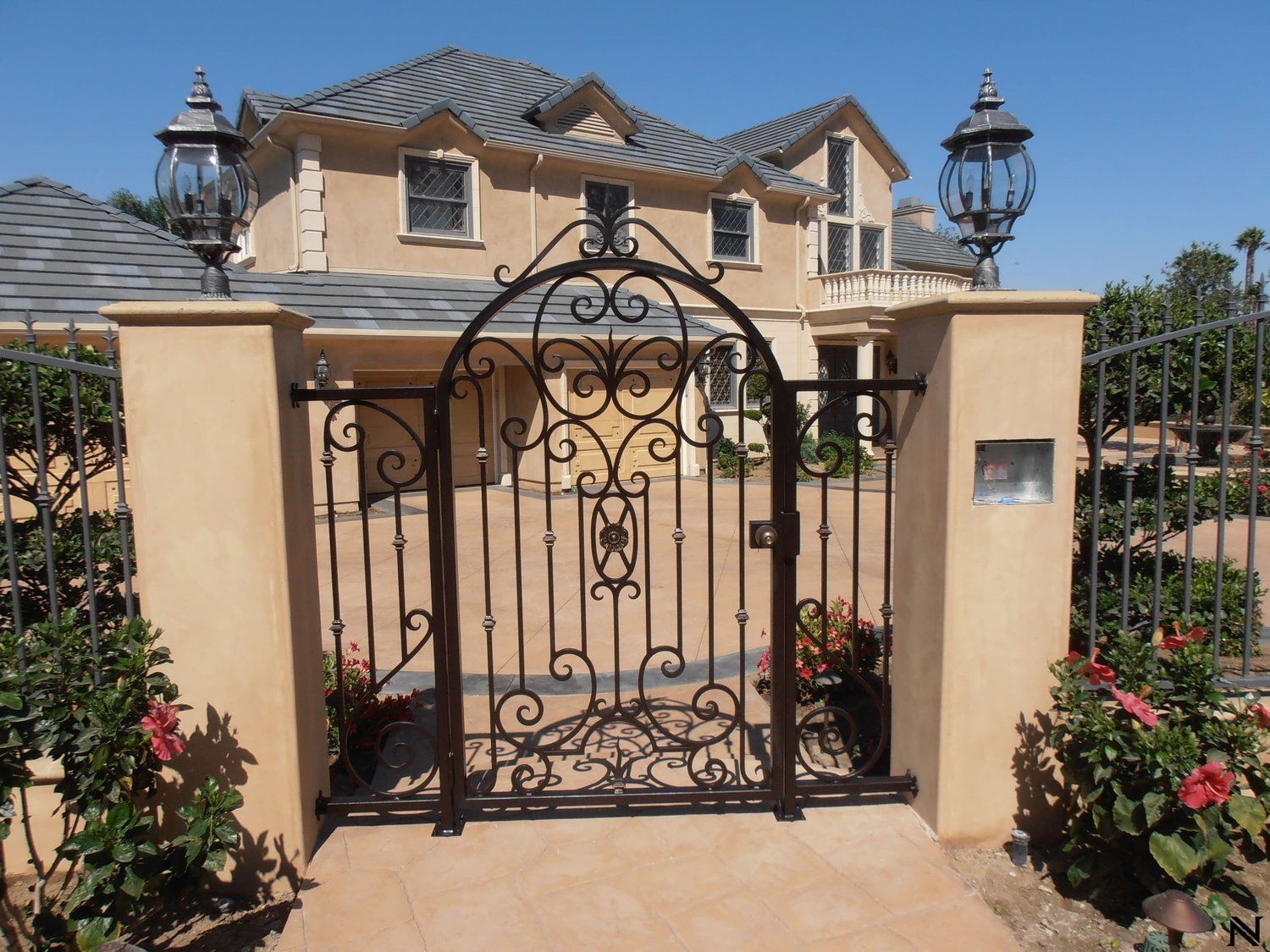 A large house with a wrought iron gate in front of it