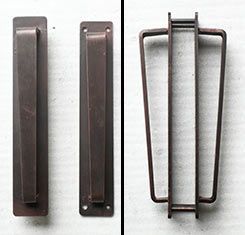 Two different types of door handles are shown on a white surface.