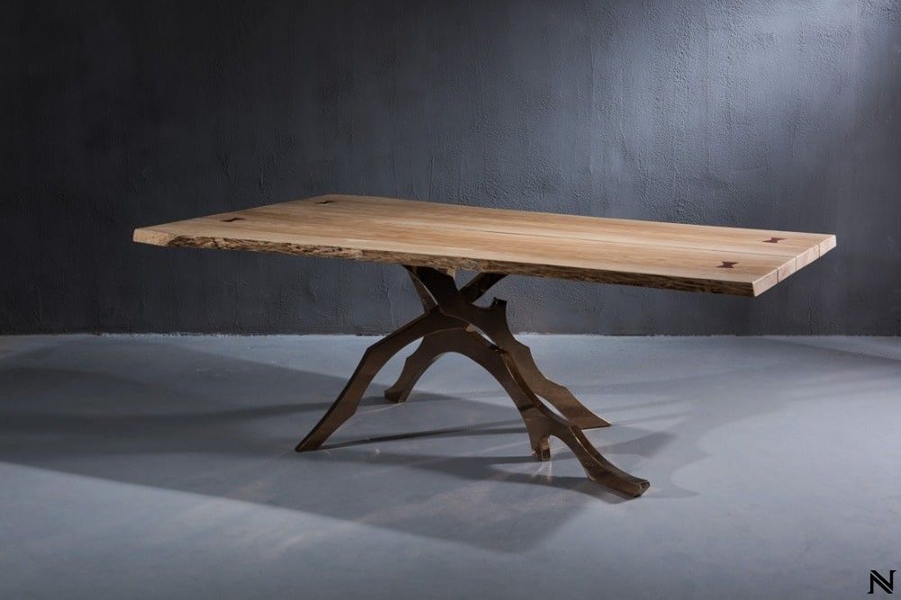A wooden table is sitting on a concrete floor in a room.