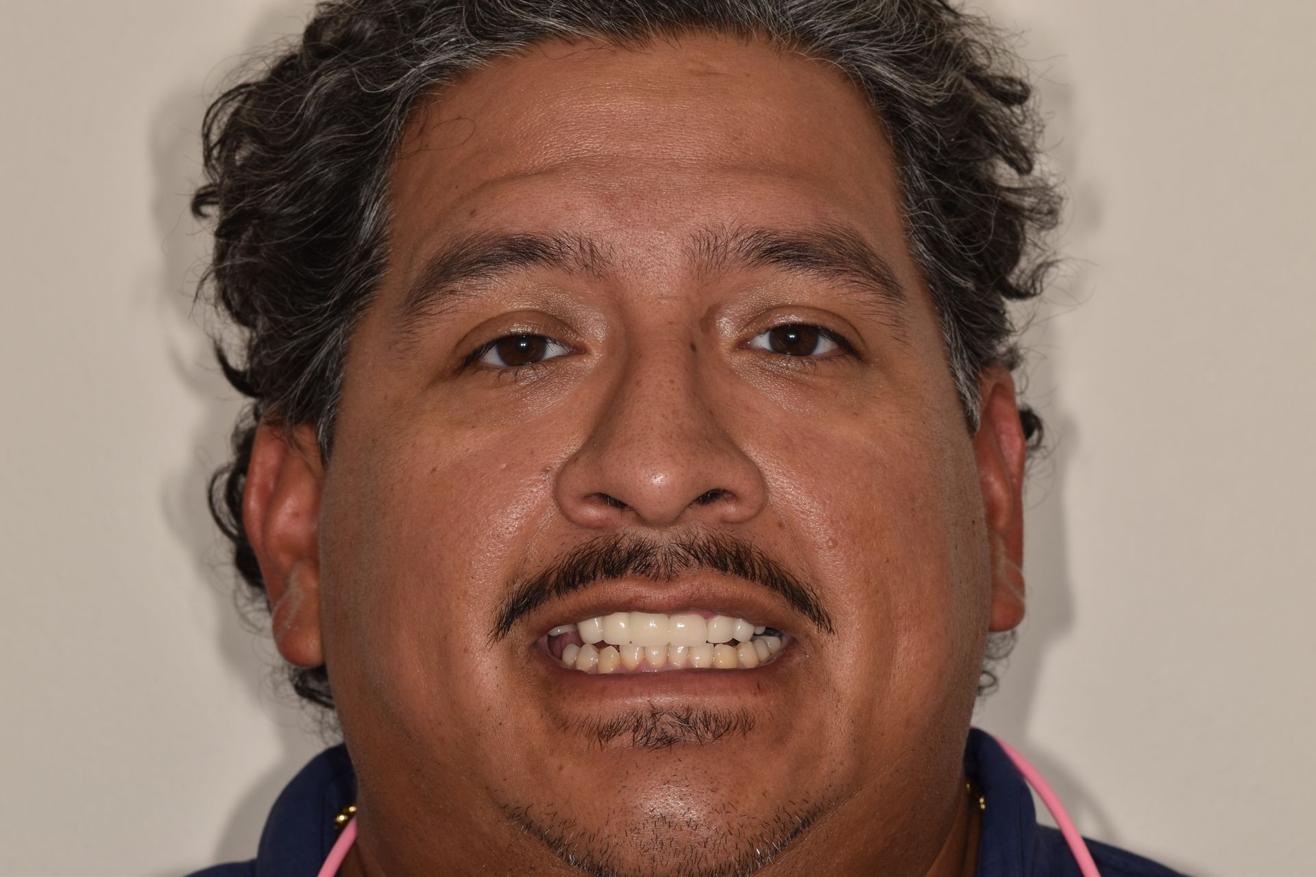 A man with a beard and mustache is smiling for the camera.