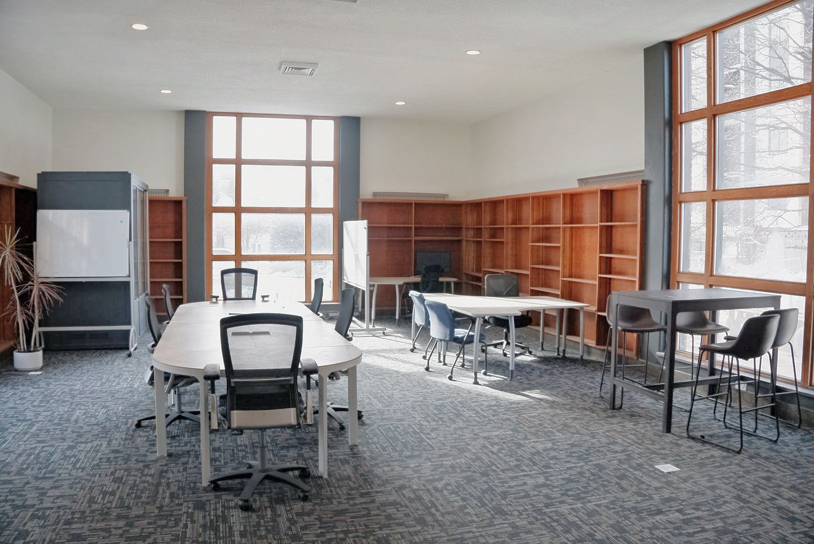 A room with tables and chairs and a couch.