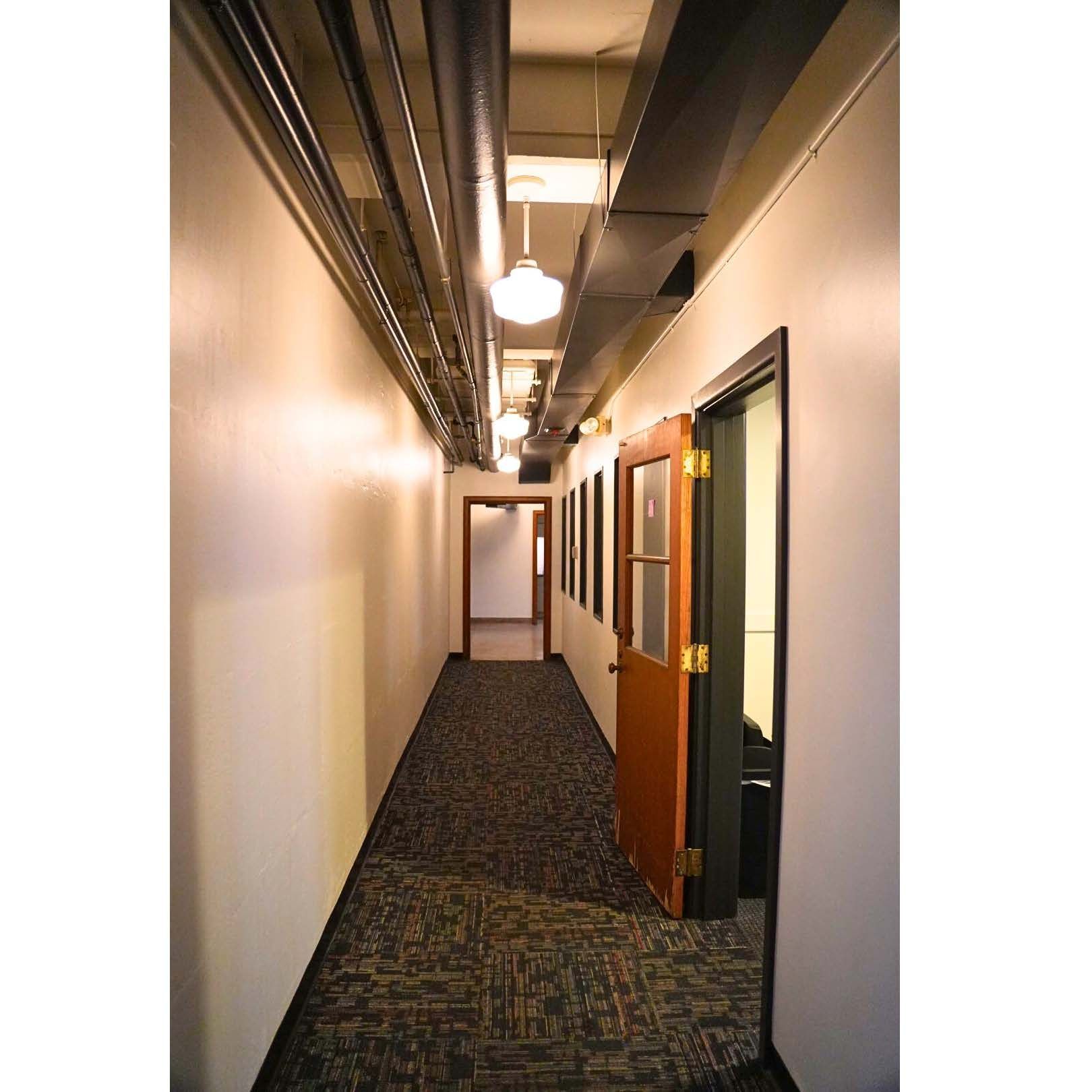 Two chairs and a table in a room with a white wall