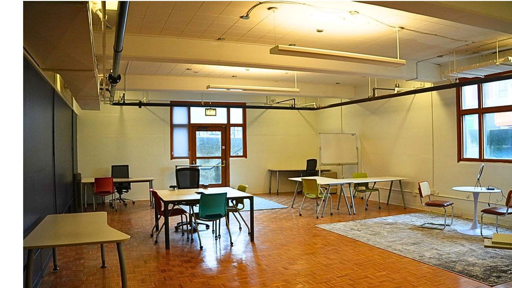 A restaurant with tables and chairs and a large window.