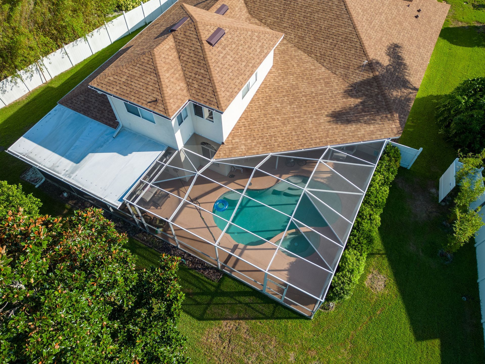 An aerial view of a house with a swimming pool