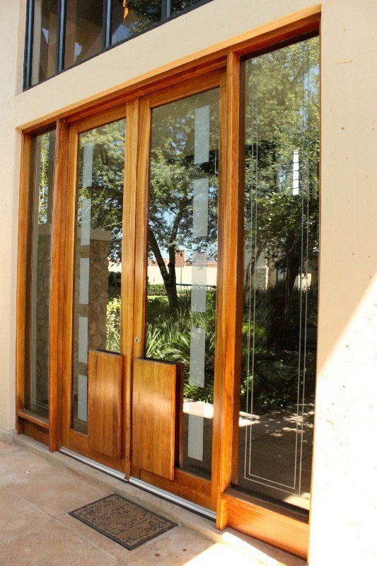 Grapedoor Custom made glass door with sandblast detail and wooden handle