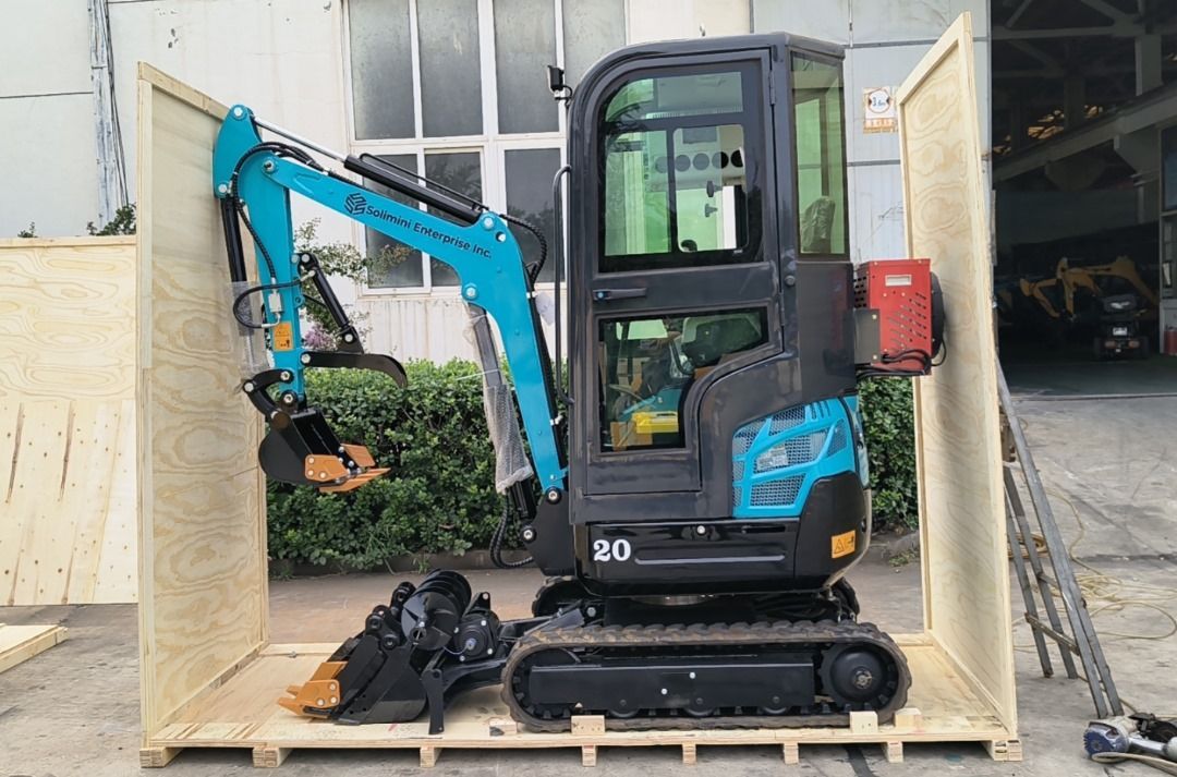 A small excavator is sitting inside of a wooden box.