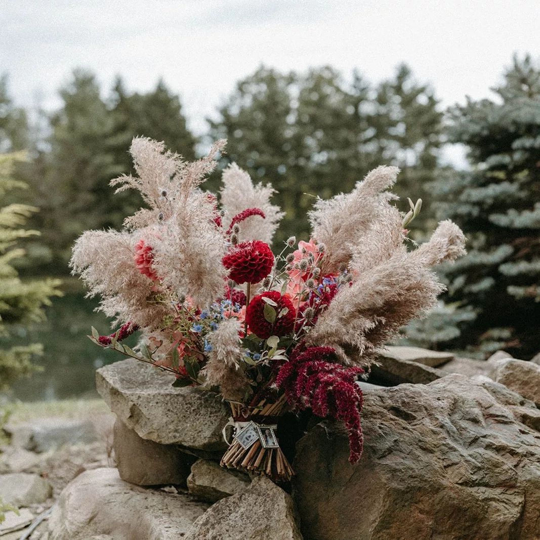 A bouquet of flowers is sitting on top of a rock.